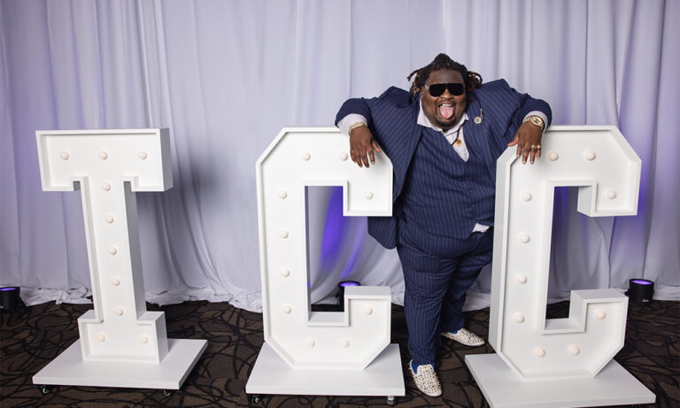 BMC - Sheann Stokes-Gilmore poses with the "TCC" letters at the TCC Foundation Vision Dinner.