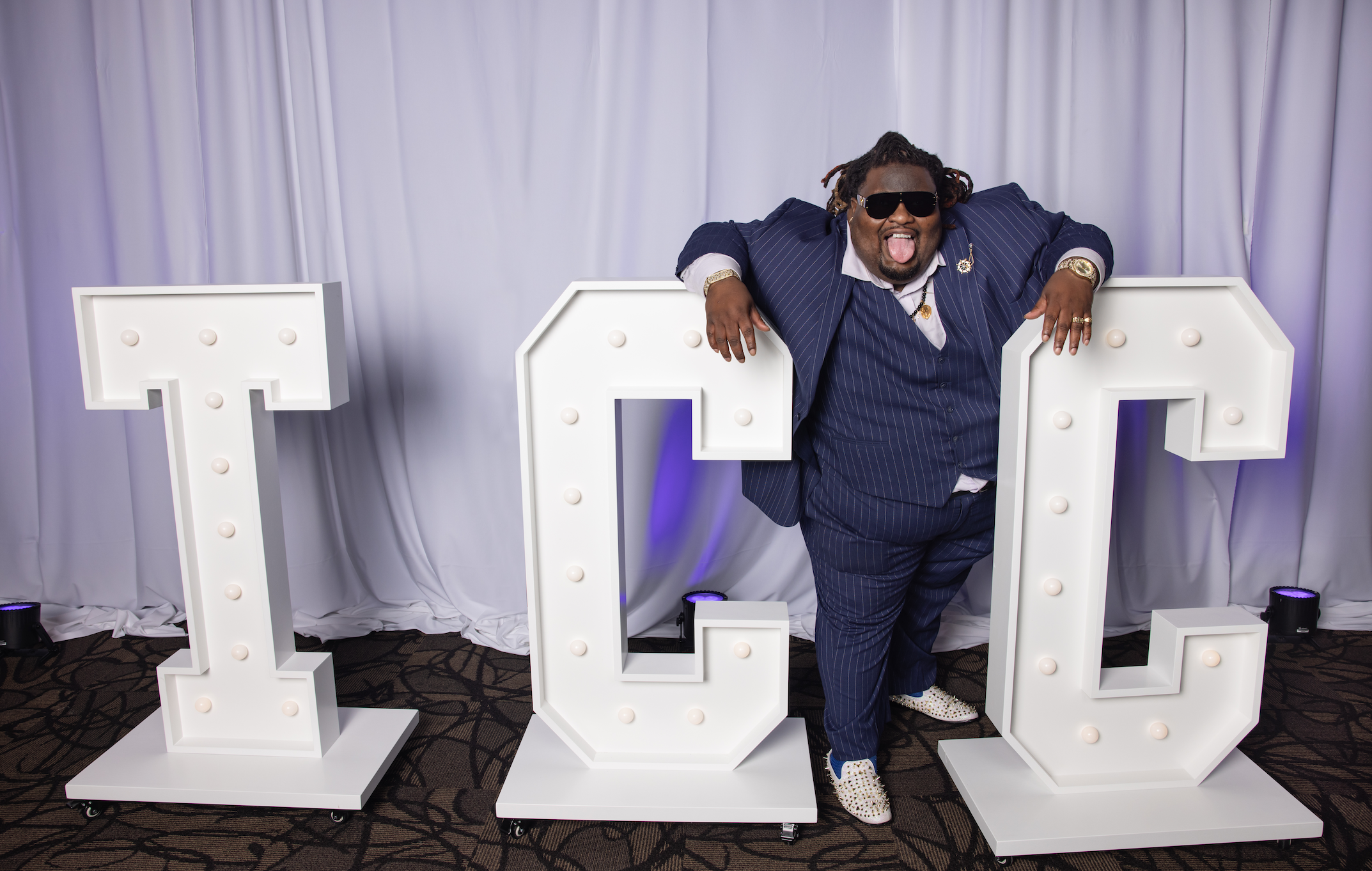 BMC - Sheann Stokes-Gilmore poses with the "TCC" letters at the TCC Foundation Vision Dinner.