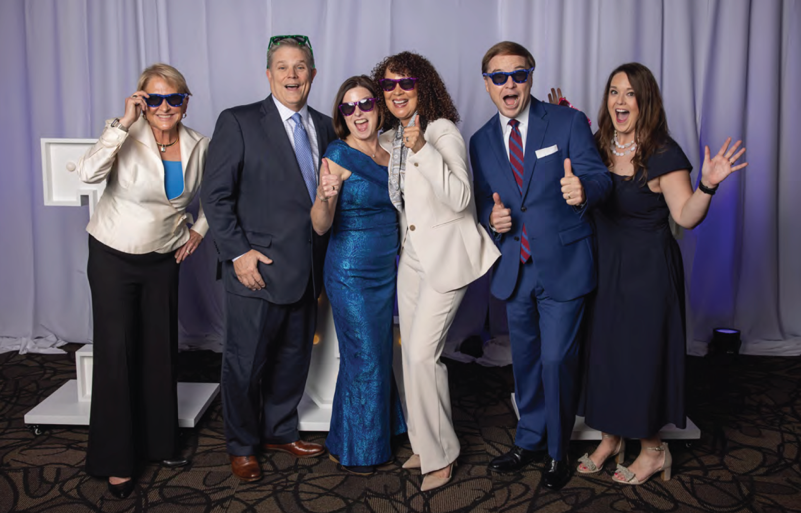TCC Foundation team members pose excitedly with TCC letters at 2025 Vision Dinner.