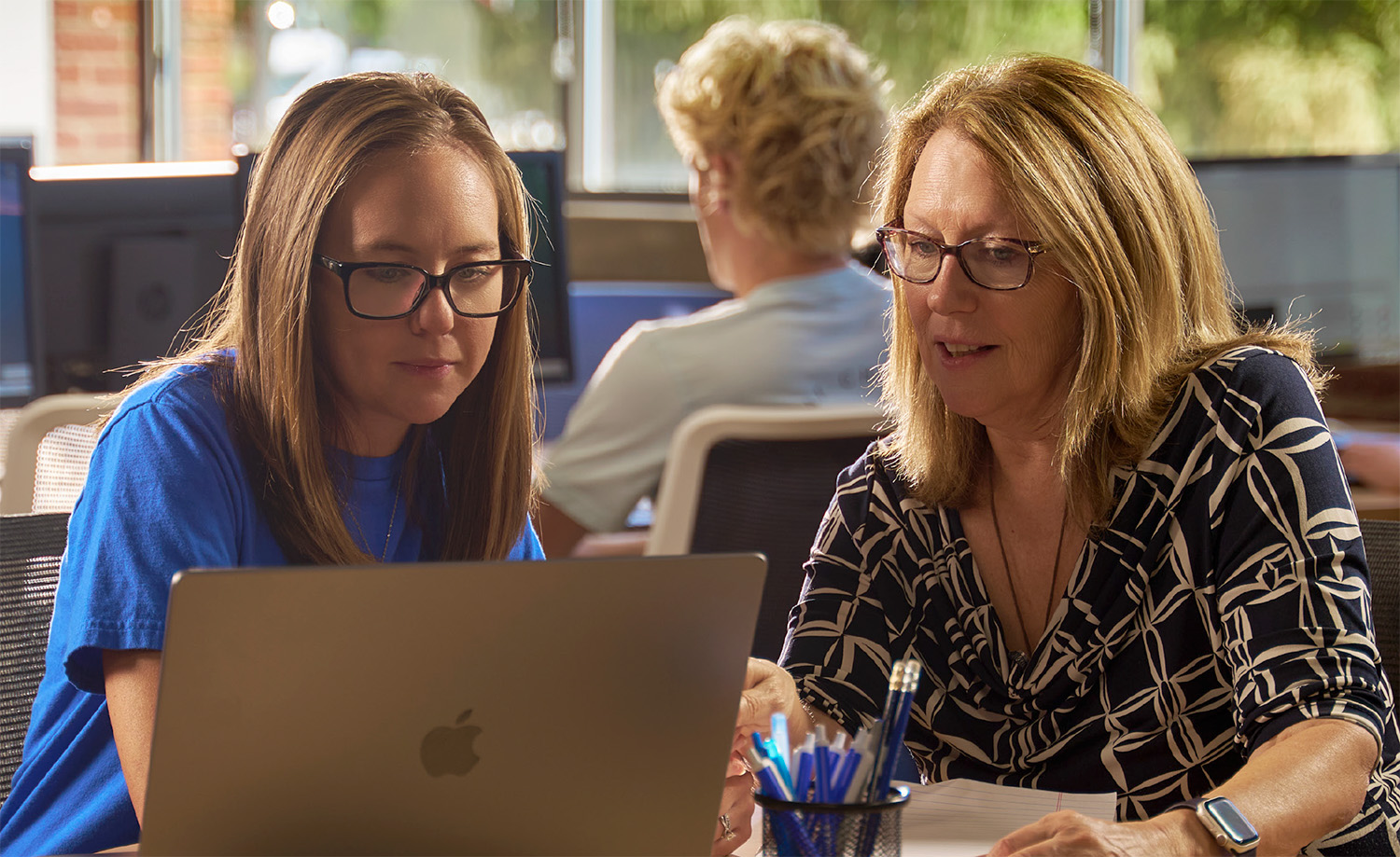 A TCC Writing tutor coaches a student at a TCC Writing Center.